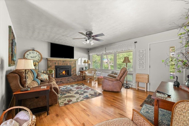 10 Crescent Dr, Deadwood, SD 57732 - living room with a brick fireplace, wood finished floors, and a ceiling fan