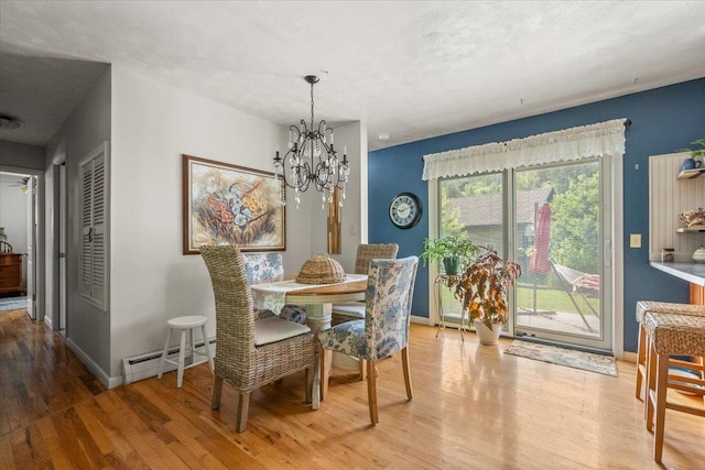 10 Crescent Dr, Deadwood, SD 57732 - dining room featuring a baseboard radiator, wood finished floors, and a chandelier