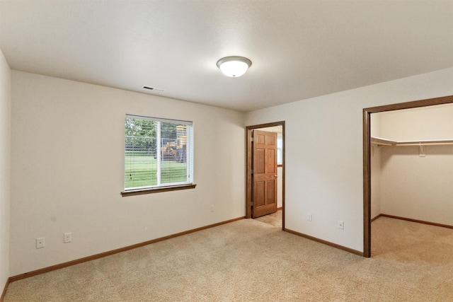 1205 Silverbrook Ln, Spearfish, SD 57783 - unfurnished bedroom featuring light carpet, a spacious closet, and a closet