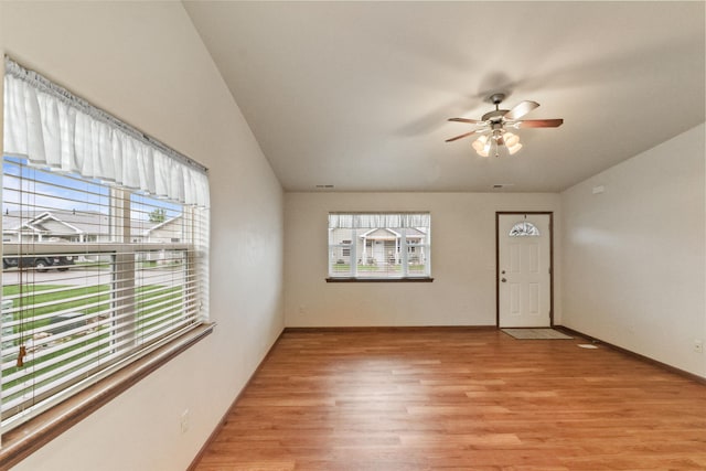 1205 Silverbrook Ln, Spearfish, SD 57783 - unfurnished living room with a ceiling fan, light wood finished floors, and vaulted ceiling