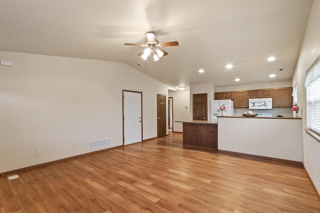 1205 Silverbrook Ln, Spearfish, SD 57783 - unfurnished living room with light wood-type flooring, a ceiling fan, vaulted ceiling, and recessed lighting