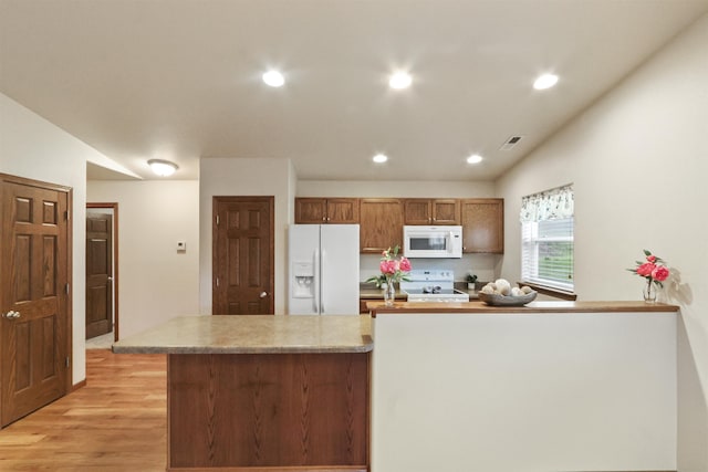 1205 Silverbrook Ln, Spearfish, SD 57783 - kitchen featuring white appliances, light wood-style floors, recessed lighting, light countertops, and brown cabinets