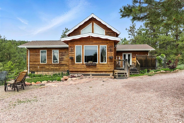 12817 Echo Rd, Hot Springs, SD 57747 - view of front of house with a wooden deck, a shingled roof, crawl space, and french doors