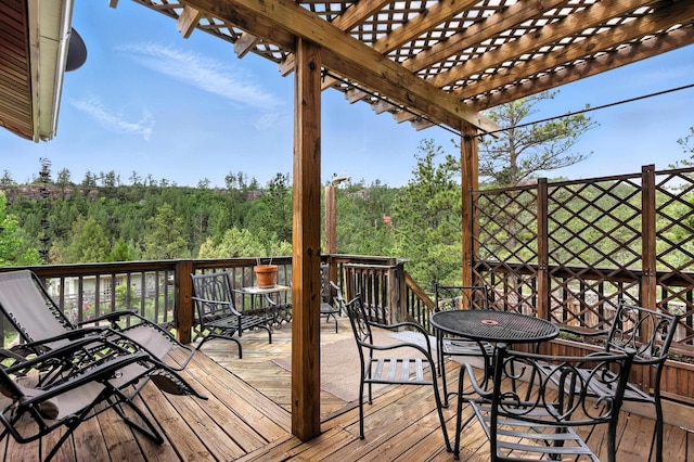 12817 Echo Rd, Hot Springs, SD 57747 - wooden terrace with a wooded view, a pergola, and outdoor dining area