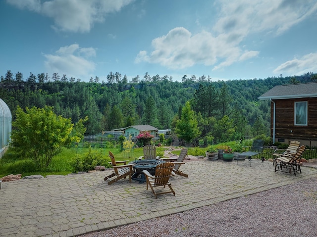 12817 Echo Rd, Hot Springs, SD 57747 - view of patio with a fire pit and a view of trees