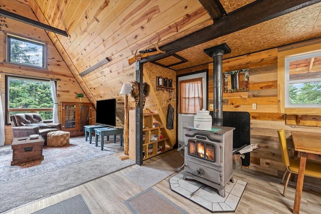 12425 Misty Ln, Nemo, SD 57759 - living room with a wood stove, healthy amount of natural light, wood walls, wood finished floors, and vaulted ceiling