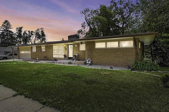 4103 W Main St, Rapid City, SD 57702 - ranch-style home featuring a garage, a yard, brick siding, and a chimney