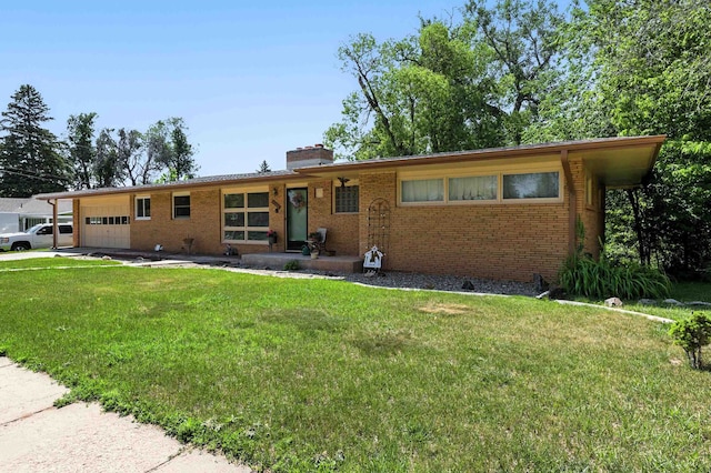 4103 W Main St, Rapid City, SD 57702 - ranch-style house with brick siding, a front lawn, a chimney, and an attached garage