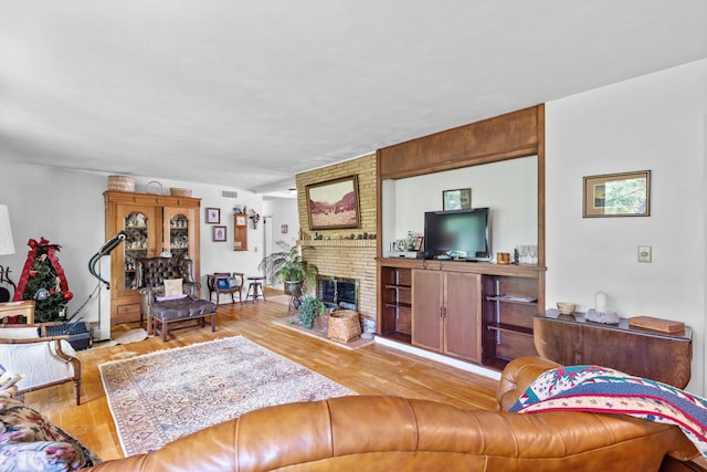 4103 W Main St, Rapid City, SD 57702 - living room featuring light wood-type flooring and a brick fireplace