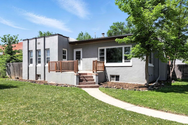 803 W St, Rapid City, SD 57701 - view of front of home with stucco siding and a front lawn