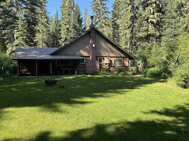 21454 US Highway 85, Lead, SD 57754 - rear view of property with a yard, a metal roof, log exterior, and a view of trees