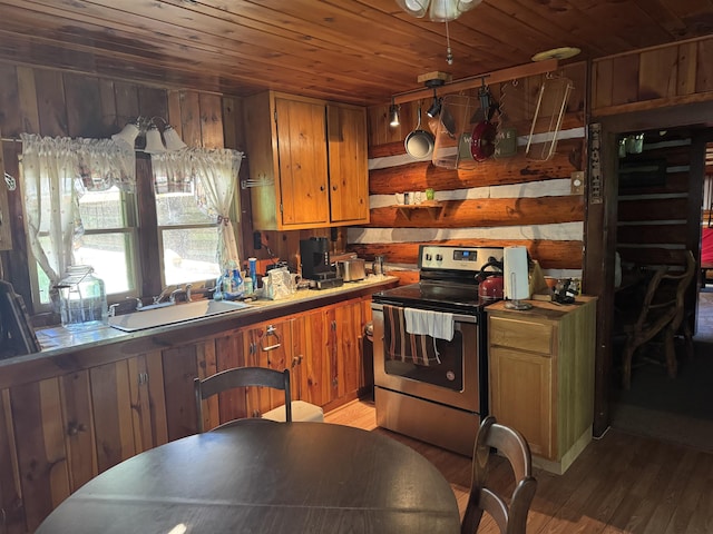 21454 US Highway 85, Lead, SD 57754 - kitchen with electric stove, wood ceiling, light wood-style flooring, brown cabinets, and light countertops