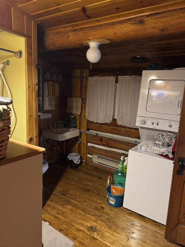 21454 US Highway 85, Lead, SD 57754 - washroom featuring stacked washer / dryer, wood finished floors, and a baseboard heating unit