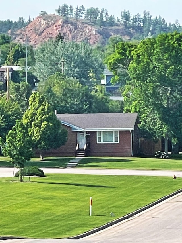 2102 Albany Ave, Hot Springs, SD 57747 - view of front of house featuring a front yard and brick siding
