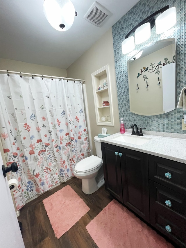 2102 Albany Ave, Hot Springs, SD 57747 - full bathroom with wood finished floors, vanity, tasteful backsplash, and curtained shower