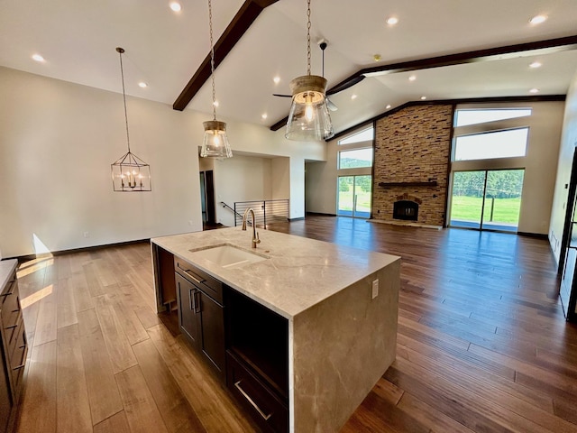 25809 Sidney Trl, Custer, SD 57730 - kitchen featuring ceiling fan, open floor plan, a fireplace, light stone countertops, and high vaulted ceiling