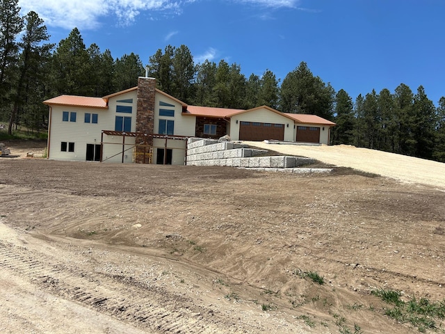 25809 Sidney Trl, Custer, SD 57730 - view of front of house with a chimney, a metal roof, and view of scattered trees