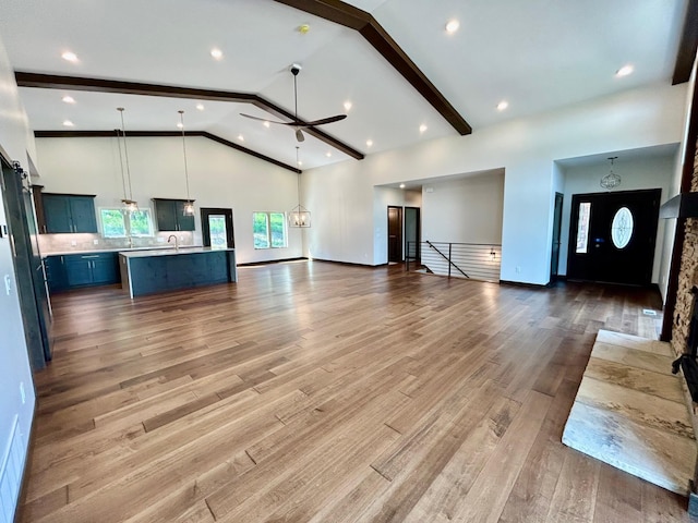 25809 Sidney Trl, Custer, SD 57730 - unfurnished living room with a ceiling fan, wood finished floors, high vaulted ceiling, and beam ceiling
