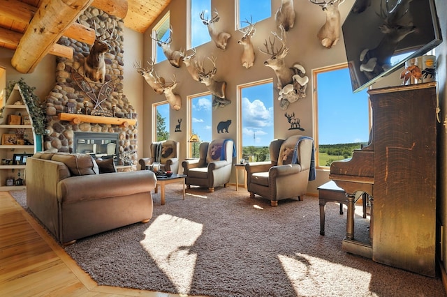 13316 Barry Ln, Sturgis, SD 57785 - living room with a towering ceiling, a wooden ceiling with exposed beams, a fireplace, and wood finished floors