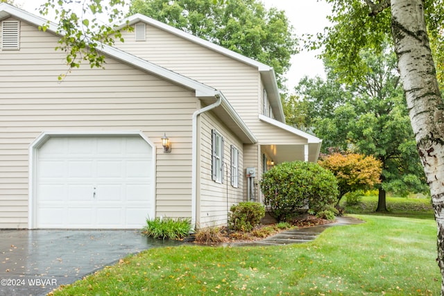 view of property exterior featuring a yard and a garage