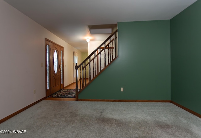 foyer entrance with carpet floors