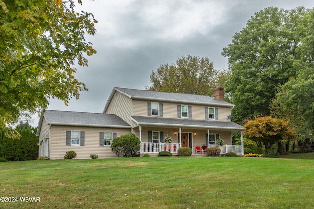 view of front of property featuring covered porch and a front yard