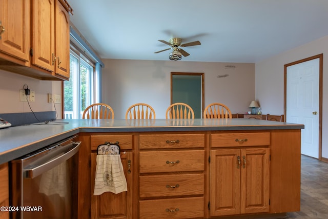 kitchen featuring kitchen peninsula, a breakfast bar, stainless steel dishwasher, and ceiling fan