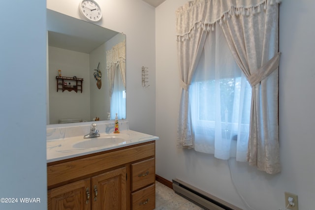 bathroom with vanity and a baseboard heating unit