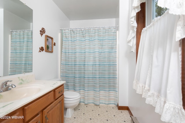 bathroom with walk in shower, tile patterned floors, vanity, and toilet