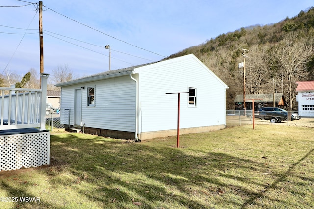 view of side of home with a lawn