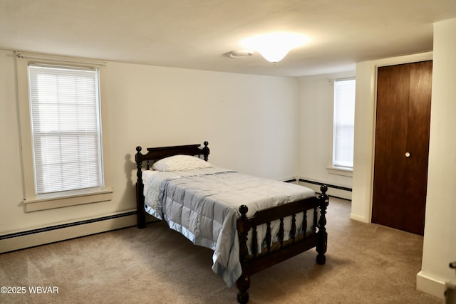 bedroom featuring a baseboard radiator, carpet, and a closet