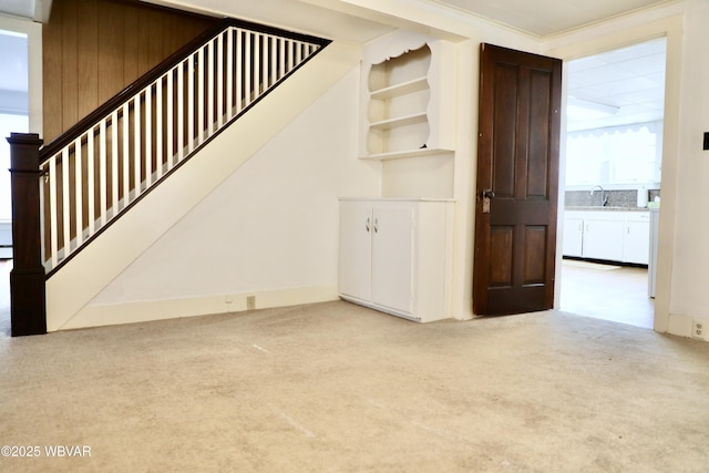 staircase with sink and carpet flooring