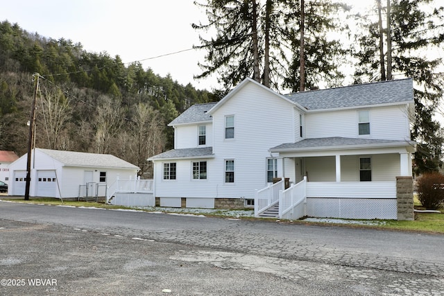 view of front of property featuring a garage and an outbuilding