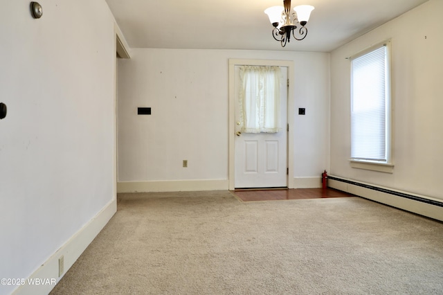 unfurnished room with an inviting chandelier, carpet flooring, and baseboard heating