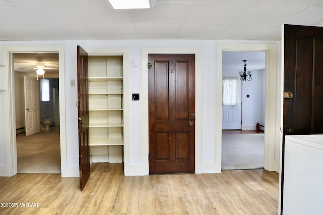 interior space with baseboard heating, washer / dryer, and light wood-type flooring