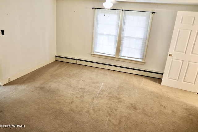 carpeted spare room featuring a baseboard radiator