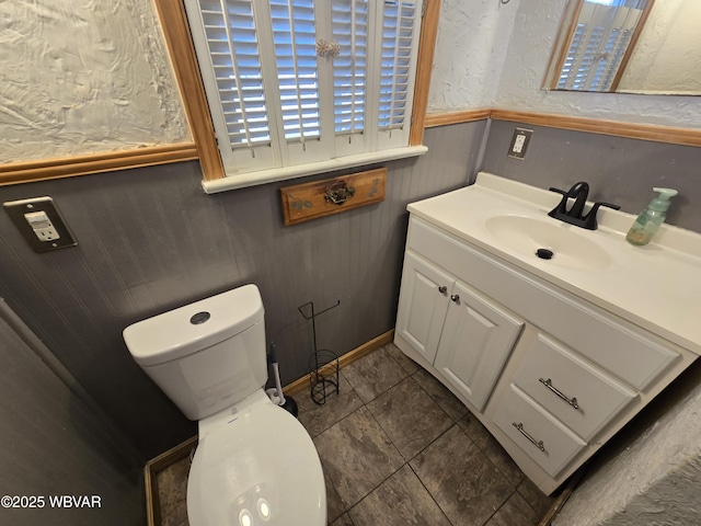 bathroom featuring tile patterned floors, vanity, and toilet