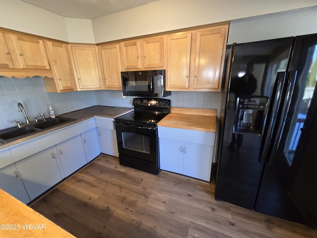 kitchen with black appliances, sink, dark wood-type flooring, and tasteful backsplash