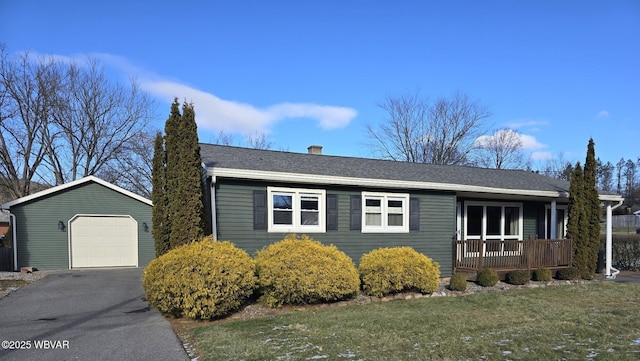 ranch-style home with a porch, a front lawn, an outdoor structure, and a garage