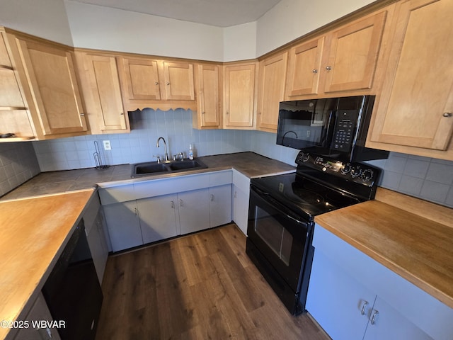 kitchen with sink, tasteful backsplash, dark hardwood / wood-style flooring, wooden counters, and black appliances