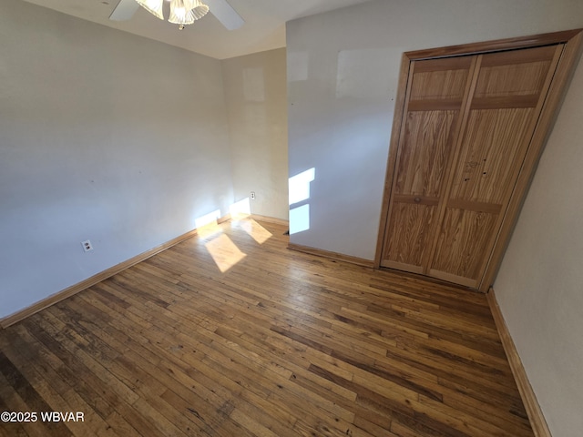 spare room with ceiling fan and dark wood-type flooring