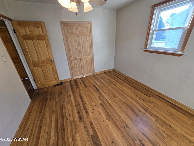 unfurnished bedroom featuring ceiling fan and wood-type flooring