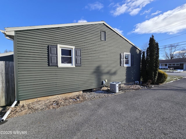 view of side of property with central AC unit