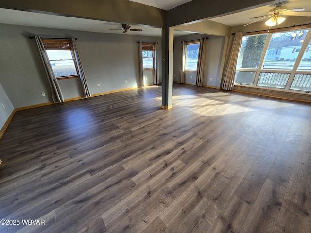 spare room featuring ceiling fan, dark hardwood / wood-style flooring, and a healthy amount of sunlight