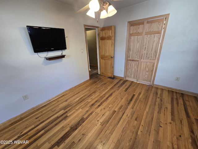 unfurnished bedroom featuring ceiling fan and wood-type flooring