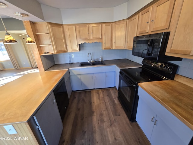 kitchen featuring wood counters, dark hardwood / wood-style flooring, sink, black appliances, and decorative light fixtures