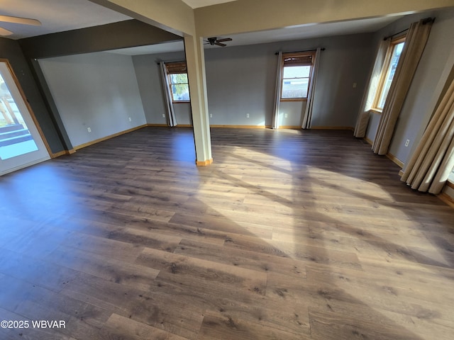 spare room with ceiling fan and dark wood-type flooring