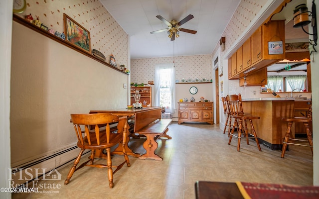 dining space featuring ceiling fan, a baseboard heating unit, and sink