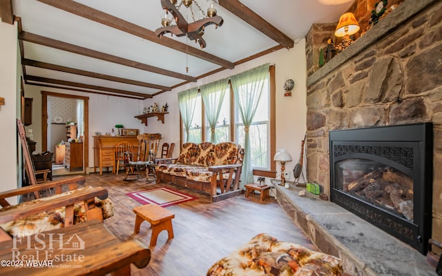 living room with beamed ceiling, wood-type flooring, and a fireplace