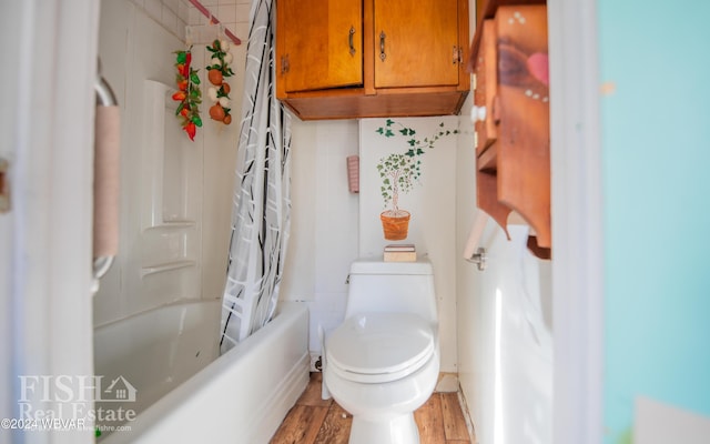 bathroom featuring shower / bath combo, hardwood / wood-style flooring, toilet, and tasteful backsplash